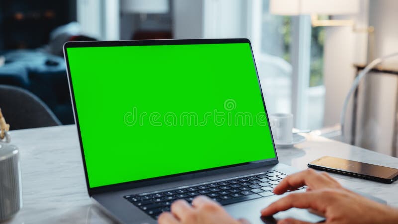 Green Screen Mock Up Display on a Laptop Computer. Close Up on Person& x27;s Hands Working from royalty free stock photo