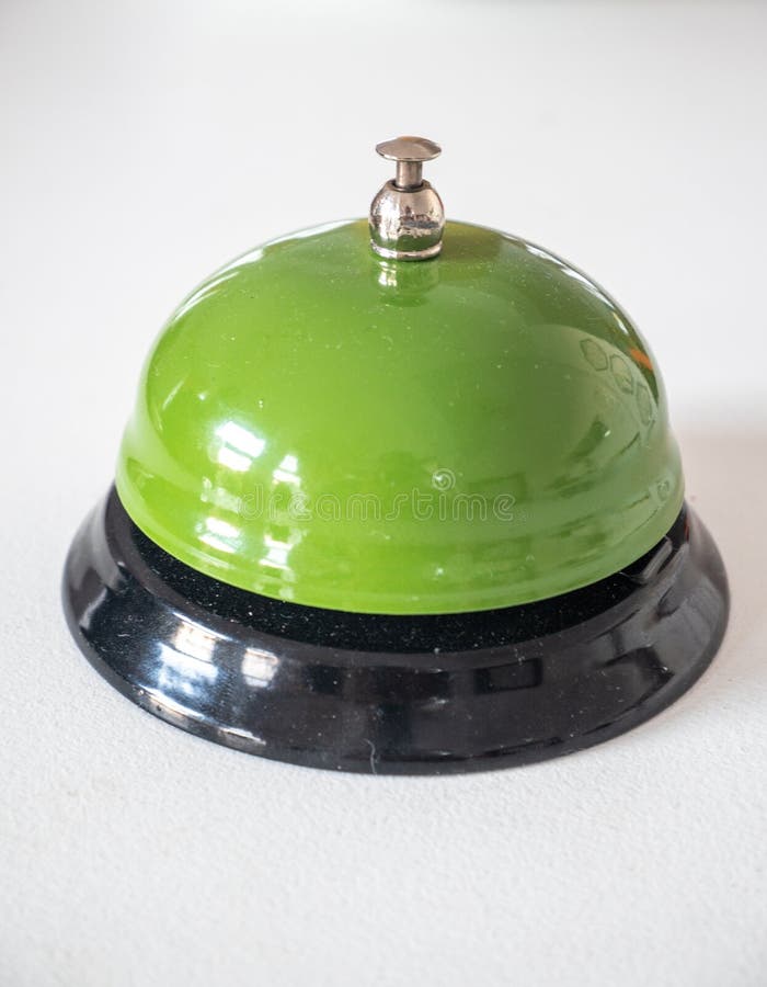 Green service bell on desk stock photo. Image of metallic 258796734