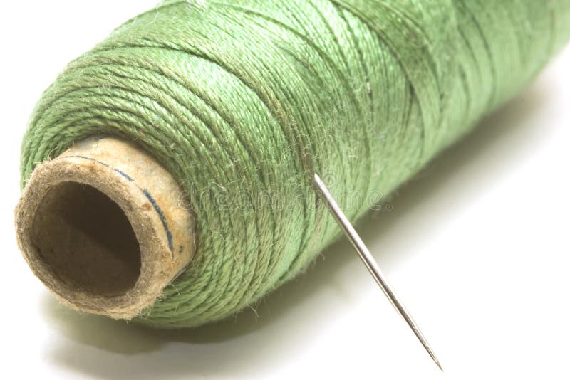 Green sewing thread and a needle sharp