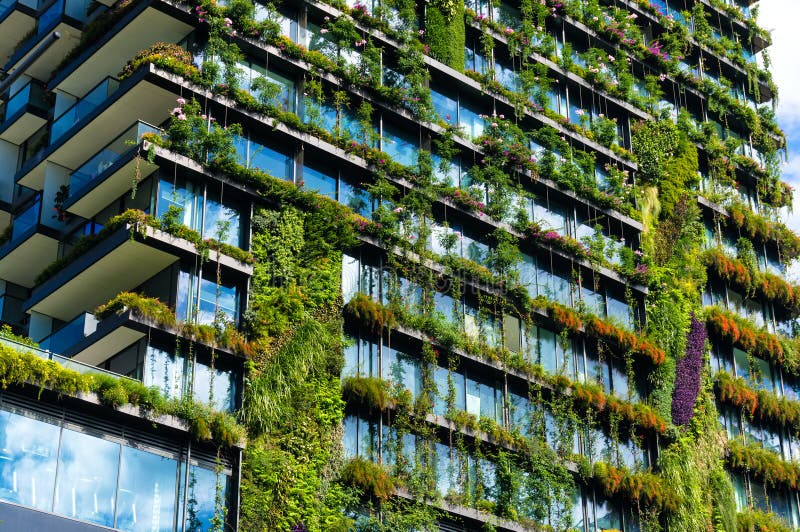 Green skyscraper building with plants on the facade