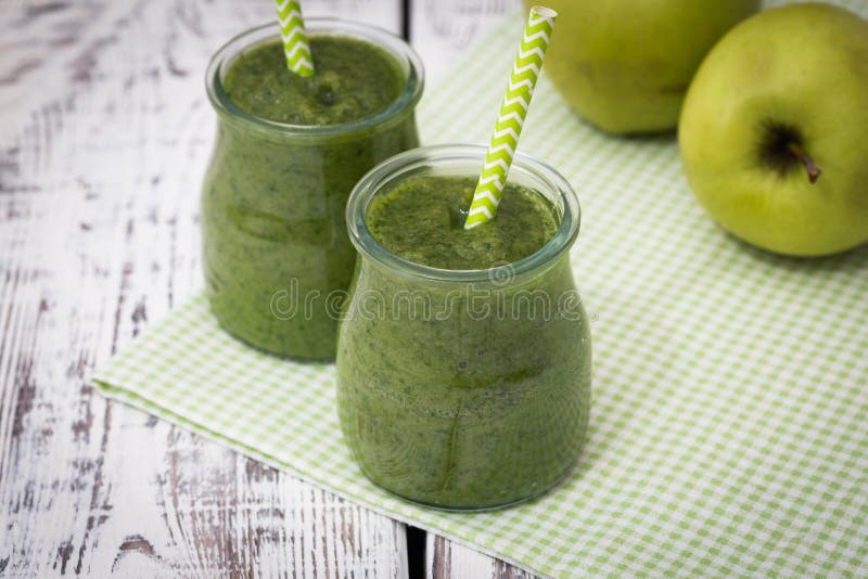 Green Smoothie with Apple,banana and Spinach on a Light Background