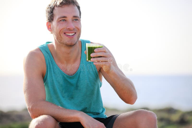 Green smoothie man drinking vegetable juice