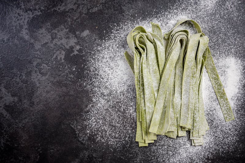 Green spinach homemade raw tagliatelle pasta stock photos Green spinach homemade raw tagliatelle pasta stock photos