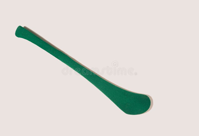 A green stick – hurleyn, a top view against beige background royalty free stock photography
