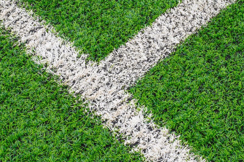 Green synthetic grass sports field with white line