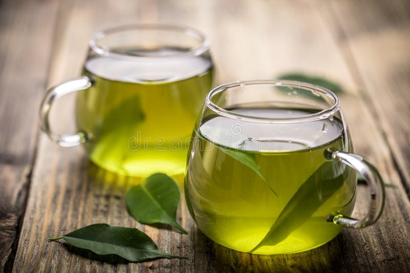 Green tea. Fresh green tea with tea leaves in the water royalty free stock image