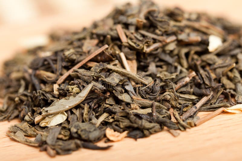 Green tea with jasmine on a wooden board stock photo