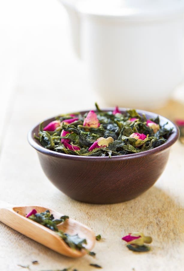 Green tea leaves with rose buds