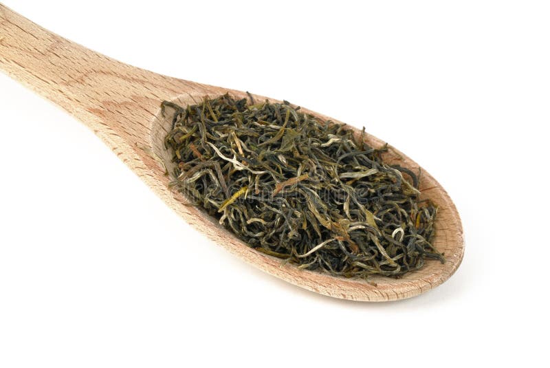 Green tea on a wooden spoon. Type is spring bud green tea