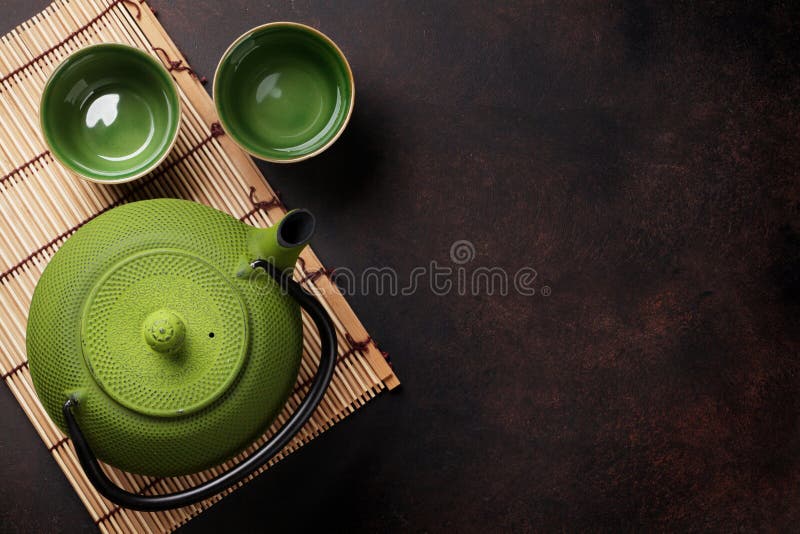 Green teapot and tea cups stock photo. Image of china 81046684