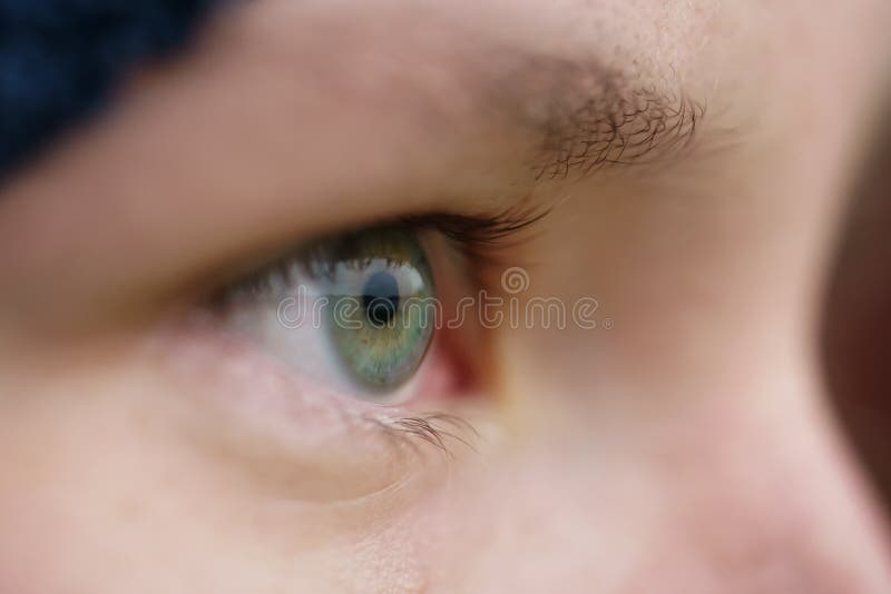 Green teen girl eye closeup front view outdoor, macro photo