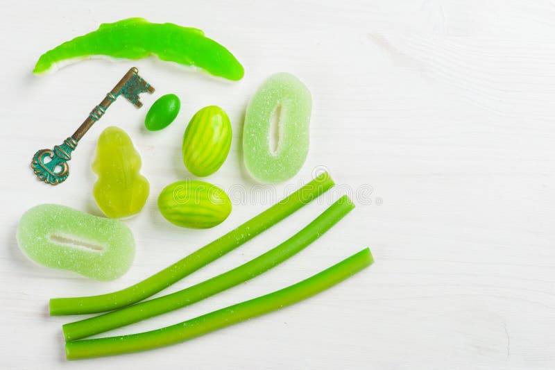 Green theme Baby Shower. On white wooden background. Key and sweets royalty free stock image Green theme Baby Shower. On white wooden background. Key and sweets royalty free stock image