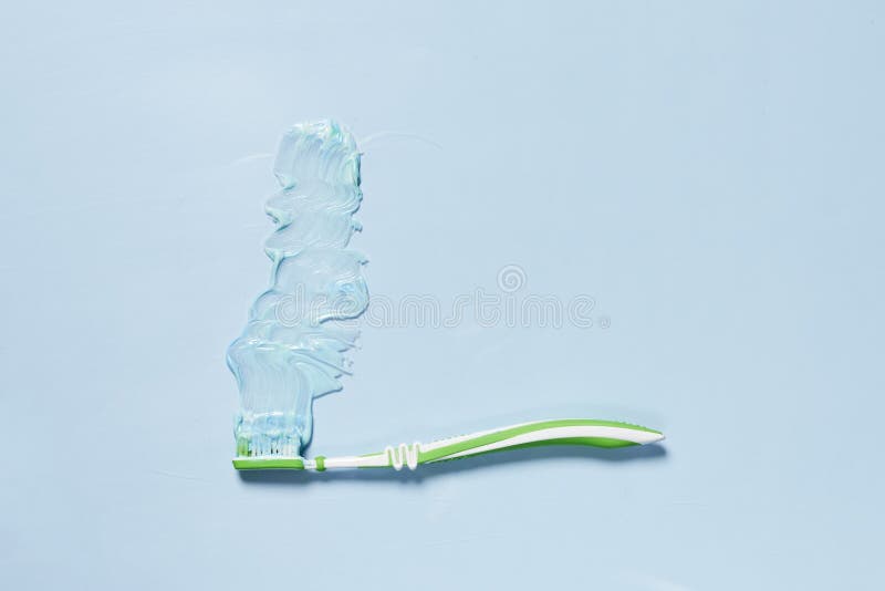 A Green Toothbrush with Blue Toothpaste on it Stock Image Image of