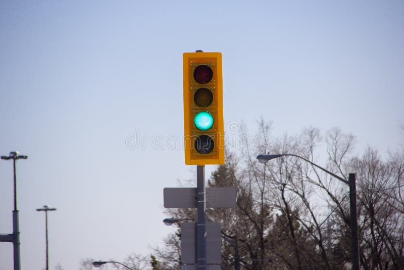 Green Traffic Light in the Middle of an Intersection Stock Image