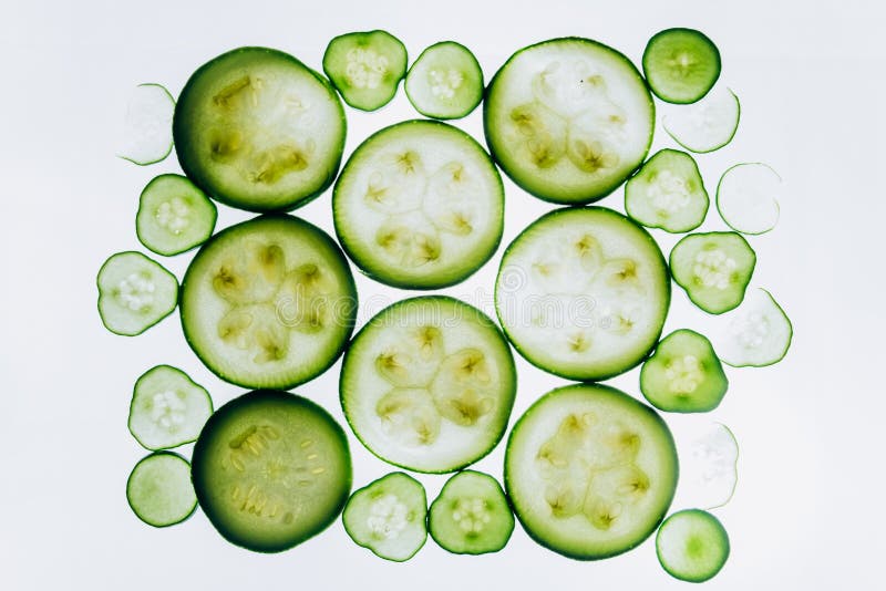 Green Translucent Slices Of Cucumber On The Background Of Bright