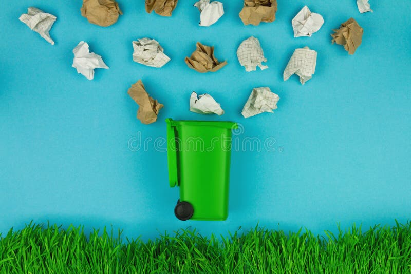 Green trash bin for paper as symbol of refuse reuse recycle concept royalty free stock image