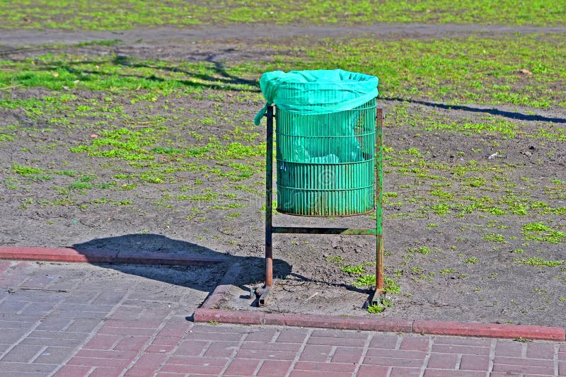 Green trash bin in sunny day, clear environment diversity royalty free stock image