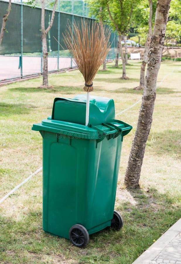 Green Trash Can and Coconut Stick Broom Stock Photo - Image of garbage ...
