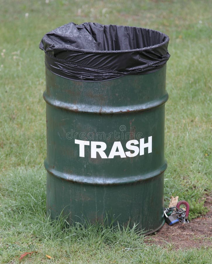 Green trash can in a park royalty free stock images