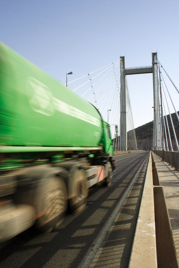 Green Truck In Motion on a cable-stayed bridge royalty free stock photo