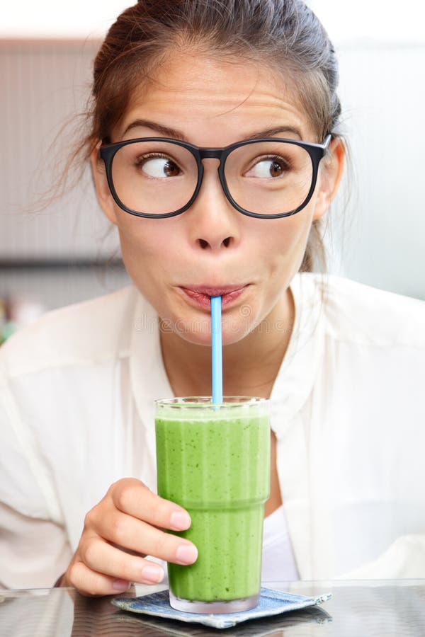 Green vegetable smoothie juice - woman drinking