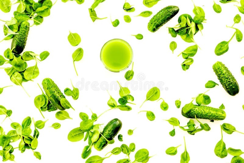 Green vegetables background with vegetable smoothies. Cucumber, arugula salad on white background top view royalty free stock photos Green vegetables background with vegetable smoothies. Cucumber, arugula salad on white background top view royalty free stock photos