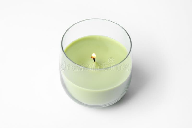 Green Wax Candle in Glass Holder and Fir Branch on White Stock Image