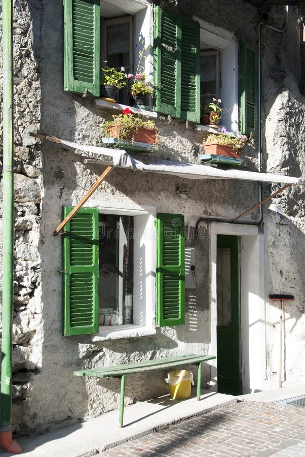 Green windows in old facade house