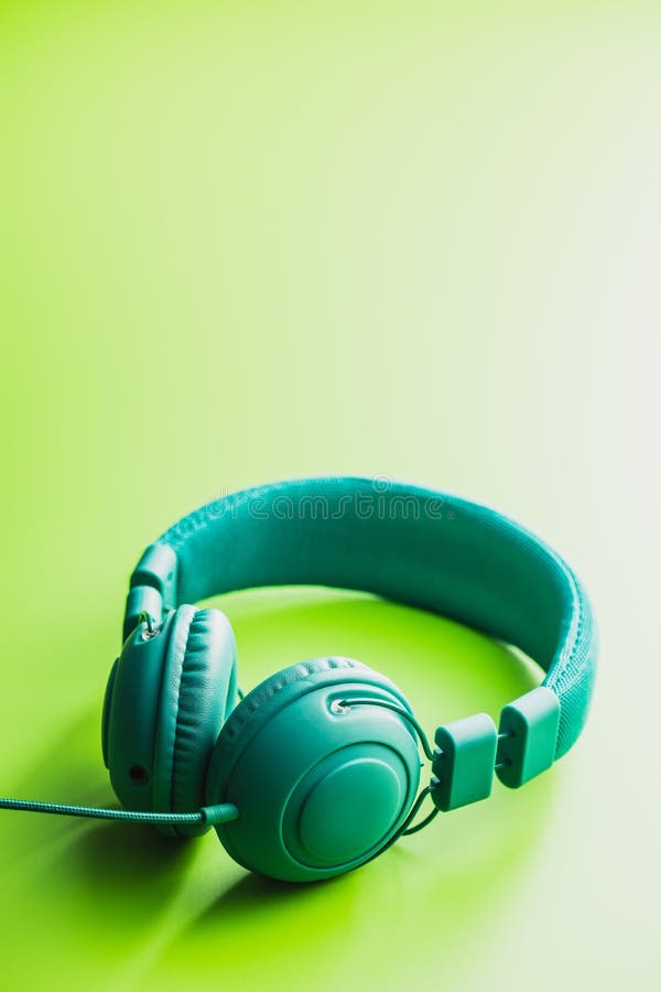 Green Wired Stereo Headphones on Green Background Stock Photo Image