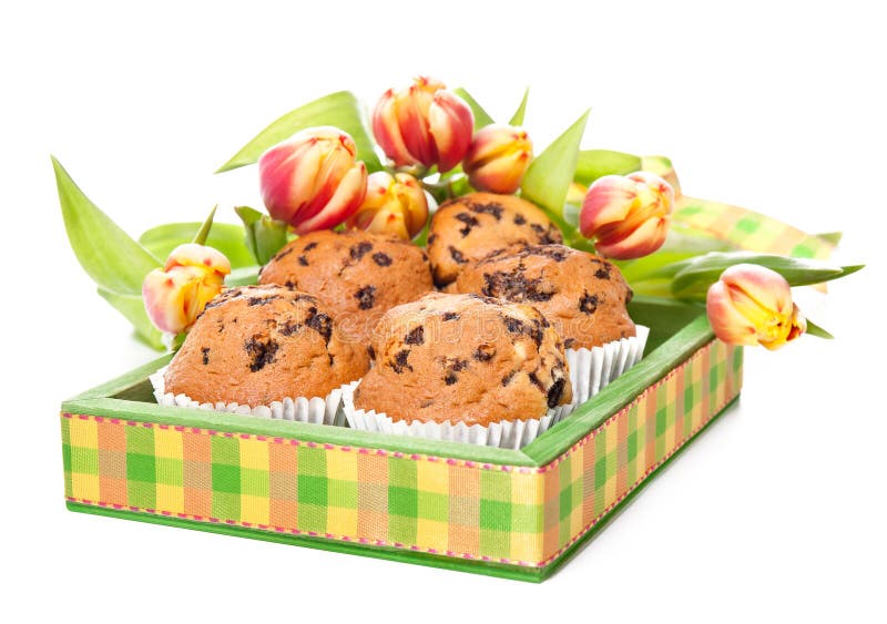 Green wooden tray with muffins and bunch of tulips