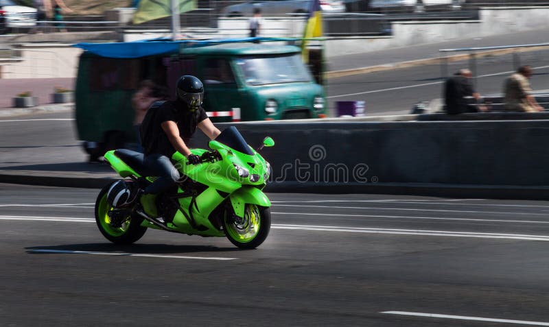 Green Yamaha sport bike Ninja travels at high speed through the city royalty free stock photo Green Yamaha sport bike Ninja travels at high speed through the city royalty free stock photo
