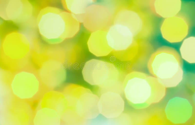 Green and yellow colored Christmas bokeh light abstract holiday background.
