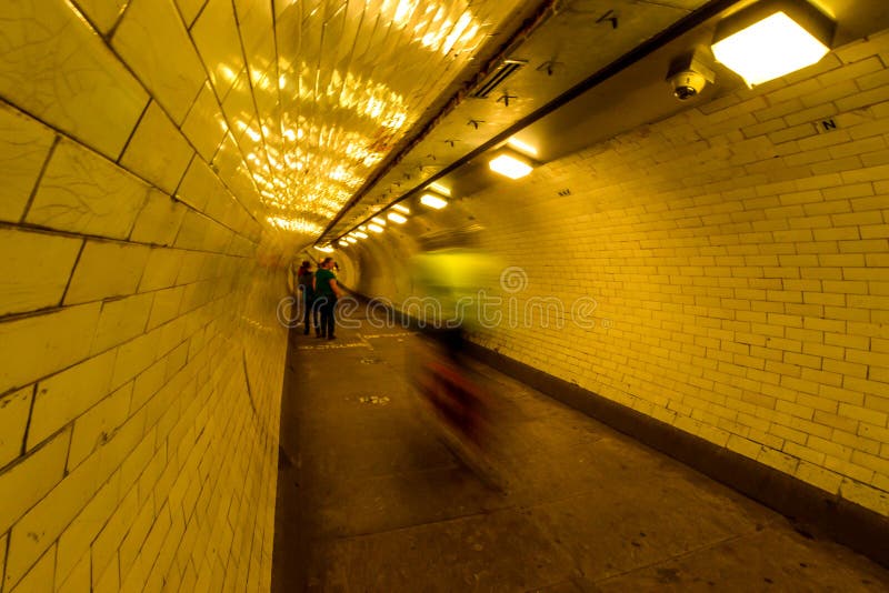 London, UK - 6/15/19 - A foot tunnel leading under the Thames river in London - UK. London, UK - 6/15/19 - A foot tunnel leading under the Thames river in London - UK