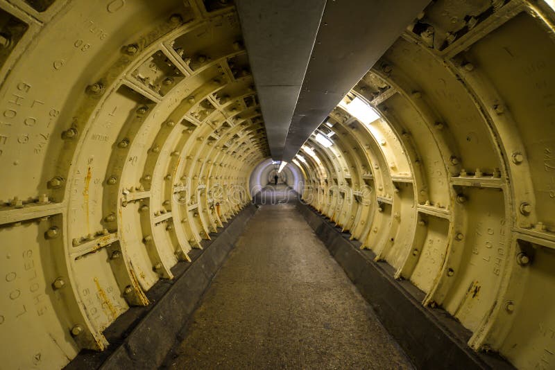 London, UK - 6/15/19 - A foot tunnel leading under the Thames river in London - UK. London, UK - 6/15/19 - A foot tunnel leading under the Thames river in London - UK