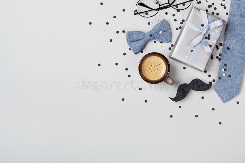 Greeting card with holiday breakfast on Happy Fathers Day with cup of coffee, gift box, glasses, bowtie and moustache top view. Flat lay
