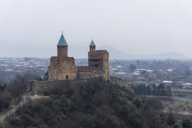 Gremi, the royal citadel and the Church of the Archangels. View of the mountains and village from a nearby hill. Gremi, the royal citadel and the Church of the Archangels. View of the mountains and village from a nearby hill.