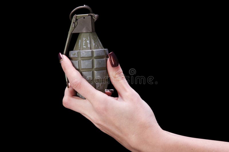 Hand grenade in girl hand on black background. Hand grenade in girl hand on black background