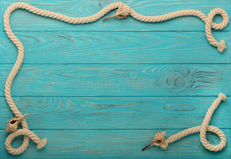 Border with rope and sea shells on a turquoise wooden background. Top view. Border with rope and sea shells on a turquoise wooden background. Top view.