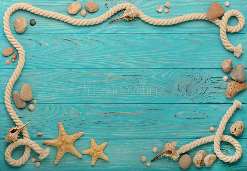 Border with rope, stones, sea shells and starfish on a turquoise wooden background. Top view. Border with rope, stones, sea shells and starfish on a turquoise wooden background. Top view.