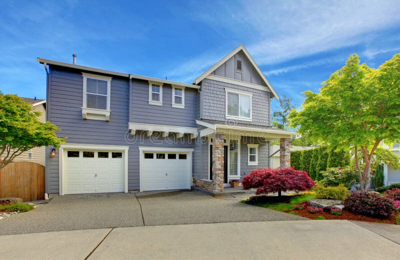 Grey American house with two garage doors.