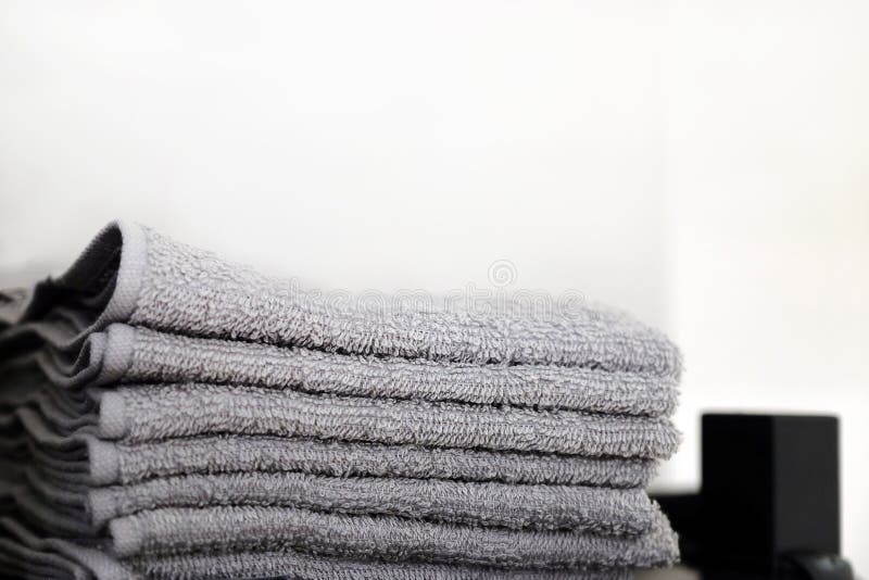 Grey Towels Towels are on the Bathroom Floor. Towels Hung on Hooks