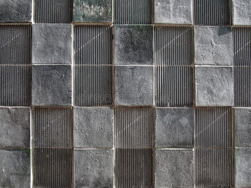 Grey concrete wall with geometric square pattern and distressed textures stock image Grey concrete wall with geometric square pattern and distressed textures stock image