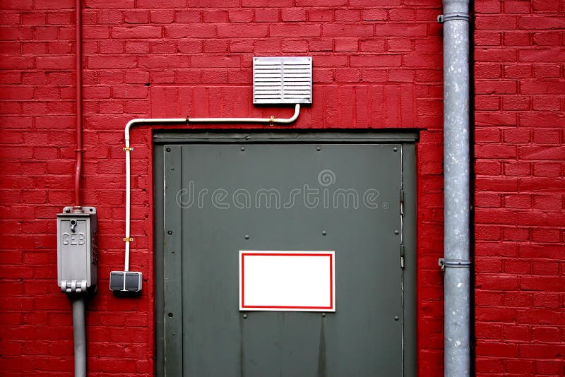 Grey door on red wall