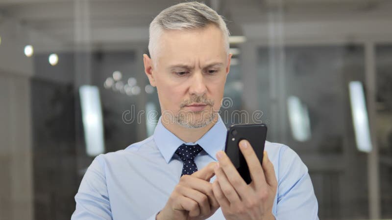 Grey Hair Businessman Using Smartphone, mensaje que mecanograf?a