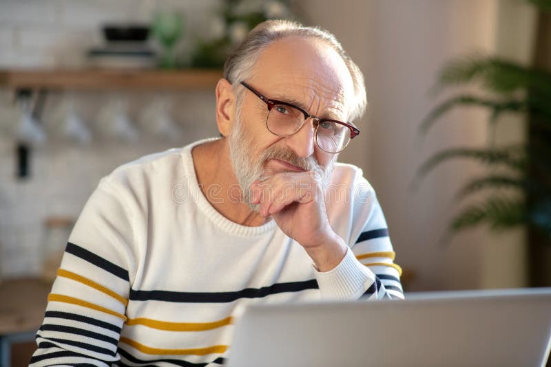 Grey-haired bearded senior man eyeglasses looking tired stock photos