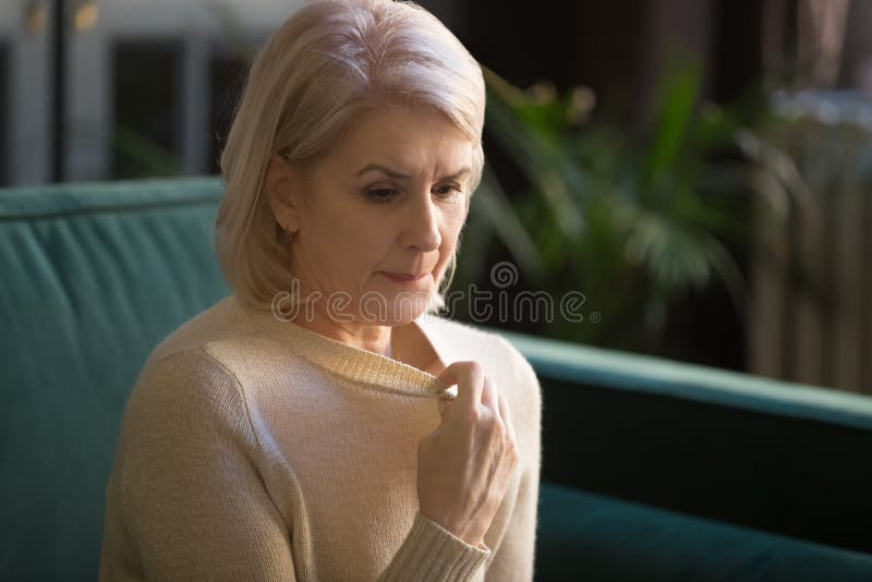 Grey haired mature woman in sweater suffering from high temperature stock images Grey haired mature woman in sweater suffering from high temperature stock images
