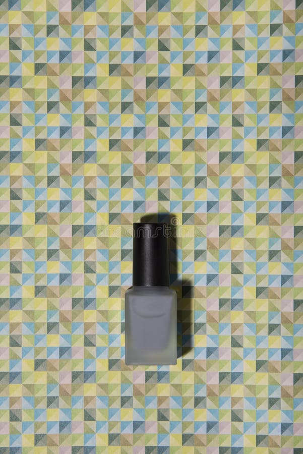 Grey nail lacquer on trendy graphic patterned colorful background. royalty free stock images Grey nail lacquer on trendy graphic patterned colorful background. royalty free stock images