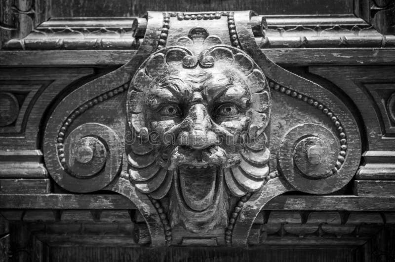 Grey stone lion head with mouth wide open. Another tooth missing. Detail of a sculpture, close up photo stock images Grey stone lion head with mouth wide open. Another tooth missing. Detail of a sculpture, close up photo stock images