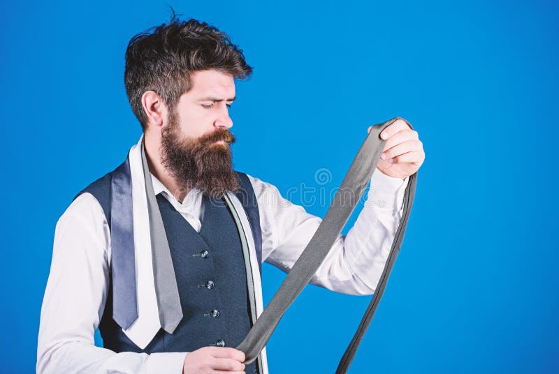 This grey tie is just the accessory. Brutal hipster holding luxury tie collection. Bearded man choosing neck tie. Offering a huge selection of ties.