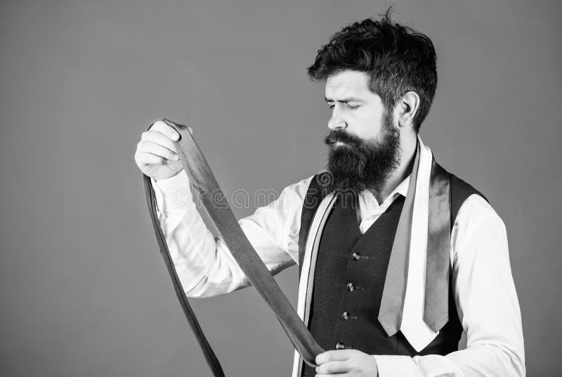 This grey tie is just the accessory. Brutal hipster holding luxury tie collection. Bearded man choosing neck tie. Offering a huge selection of ties.